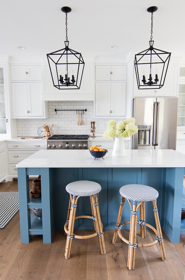 A kitchen island with white cabinets