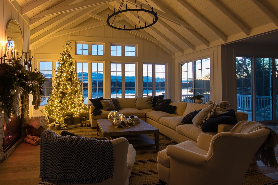 A living room filled with furniture and a large window decorated for Christmas 